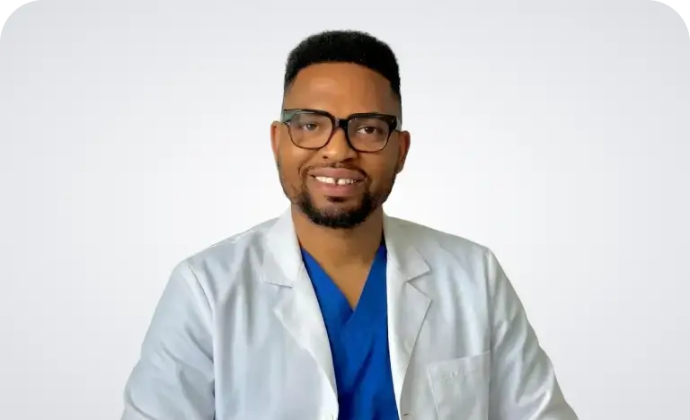 A man wearing glasses and a black shirt, looking directly at the camera with a neutral expression.