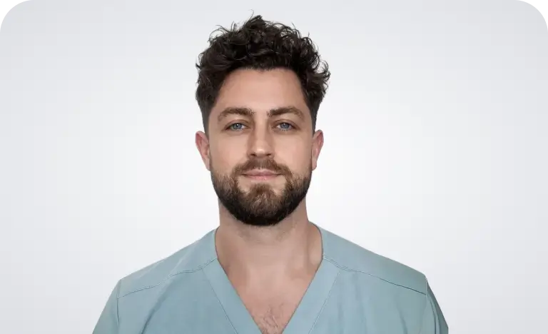 A woman with long black hair wearing a brown jacket stands confidently, showcasing her style and poise.