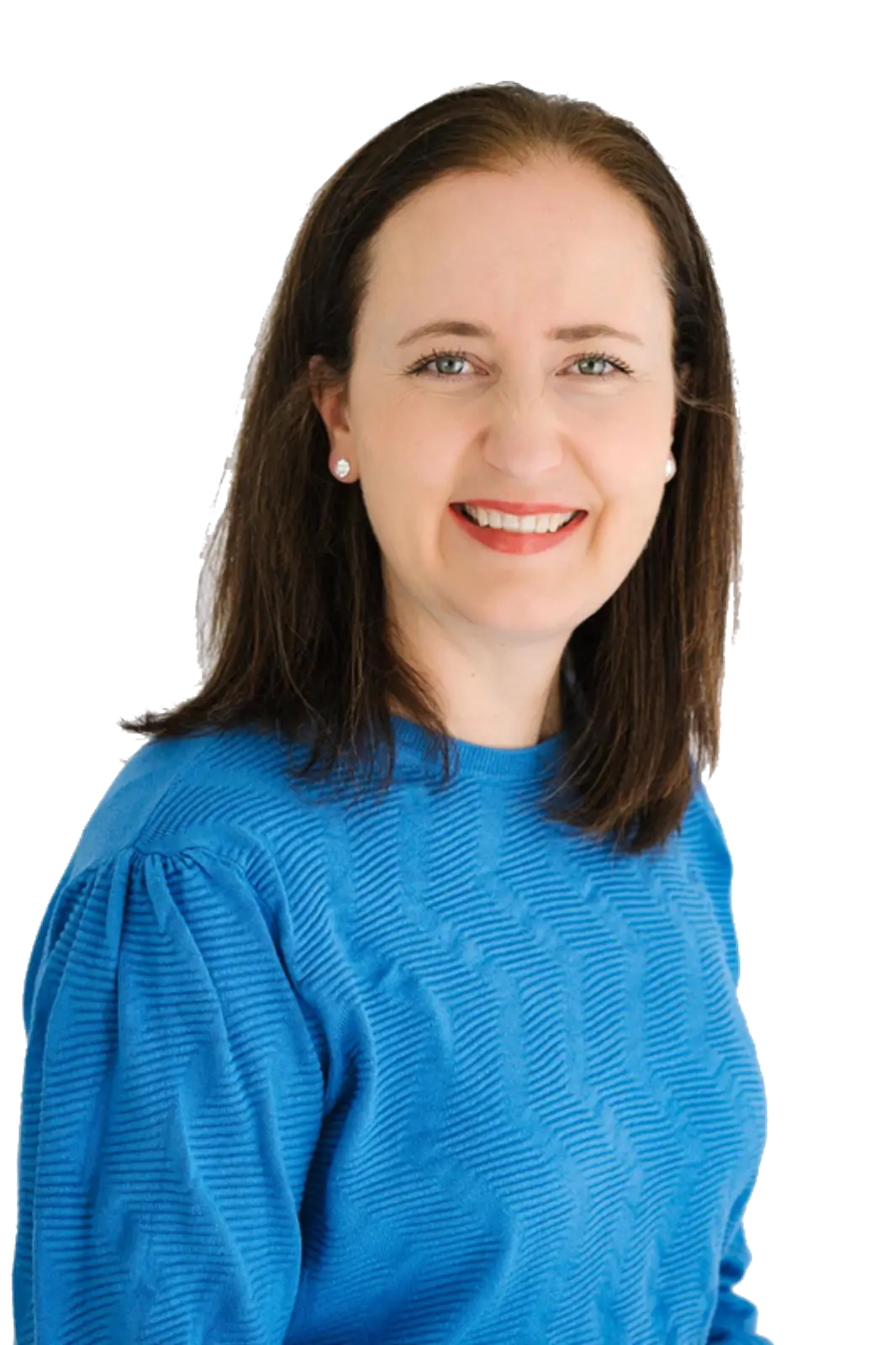 A woman wearing a blue shirt smiles warmly at the camera, exuding a friendly and approachable demeanor.